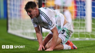 Northern Ireland's Justin Devenny crouches by the goal