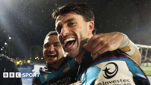 Sione Tuipulotu and Adam Hastings celebrate after Glasgow's win over Toulouse
