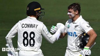 Dean Conway (left) congratulates Tom Latham on his century