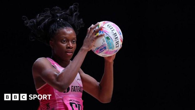 Funmi Fadoju holds the ball in her hands. She has black hair, tied up, and is wearing London Pulse's pink kit.