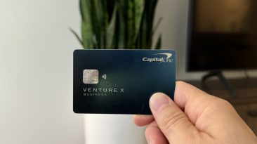 Nomadic Matt holding up his Capital One Venture X card
