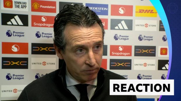 Unai Emery stands against advertising board in post match interview