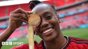 Melvine Malard of Manchester United poses for a photograph with her Adobe Women's FA Cup winners medal