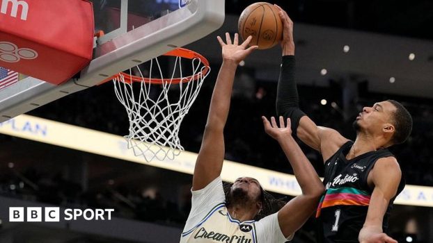 Victor Wembanyama of the San Antonio Spurs shoots the ball against Myles Turner of the Milwaukee Bucks