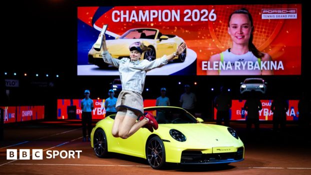 Elena Rybakina celebrates her victory in Stuttgart in front of the sports car that forms part of her winner's prize