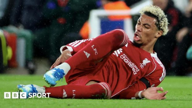 Ekitike lies on the turf in pain as concerned players from both Liverpool and Paris St-Germain tend to him