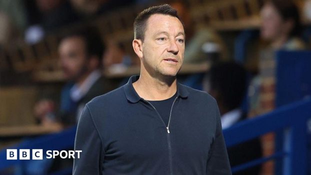 Former Chelsea player John Terry walks along the touchline at Stamford Bridge ahead of a Premier League 2 youth match in 2025
