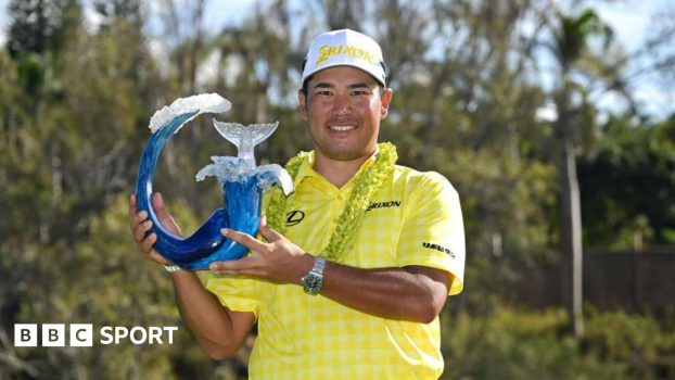 Hideki Matsuyama holding The Sentry trophy in 2025