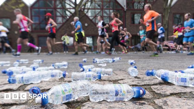Discarded plastic bottles on the side of a marathon course