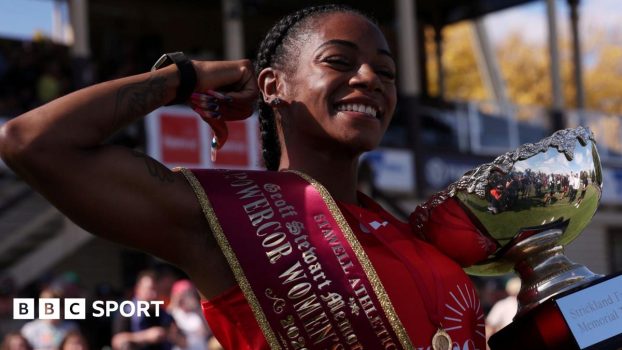 Sha'Carri Richardson celebrates with her trophy after winning the Stawell Gift