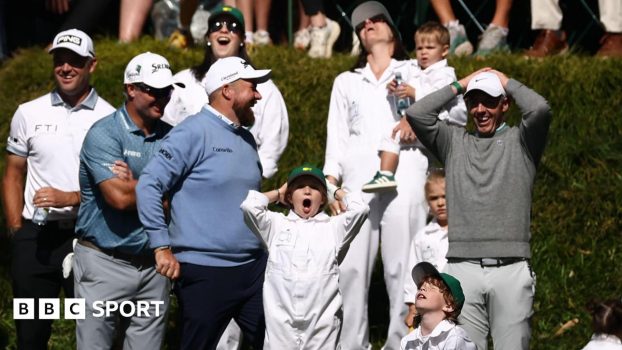 Shane Lowry, Rory McIlroy and their families react to Frankie Fleetwood hitting his ball in the water on the ninth hole of Augusta National's par three course
