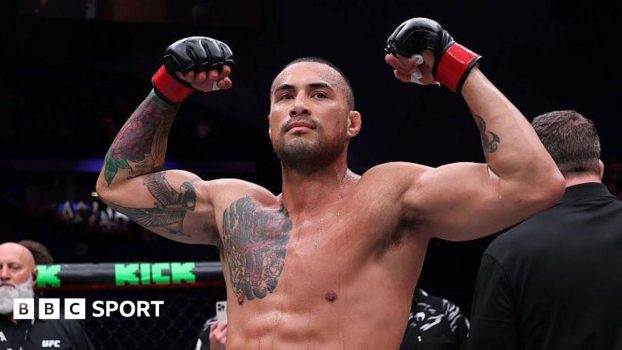 Carlos Ulberg celebrates after beating Dominick Reyes in September 2025