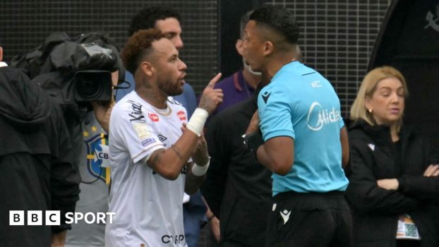 Referee Michael Salisbury signals before he awards a second goal to Matheus Cunha of Manchester United after a VAR check