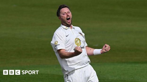 Ollie Robinson, wearing cricket whites, roars and punches both fists in celebration